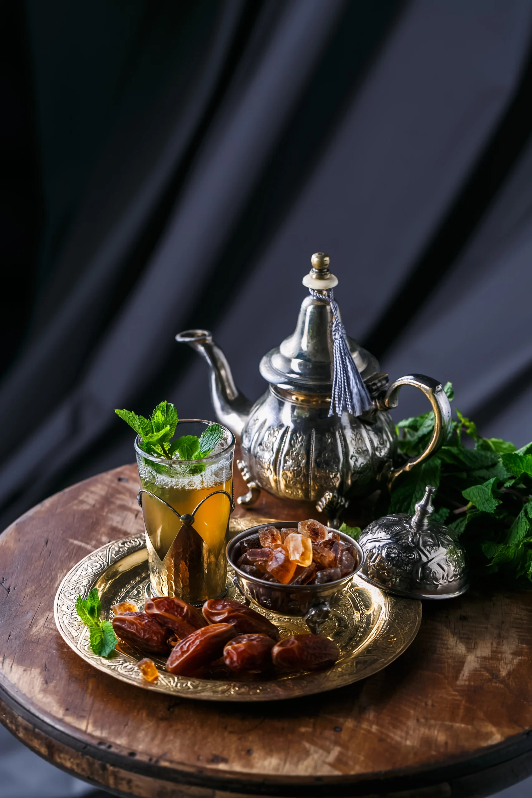 glass-of-mint-tea-with-dates-and-sugar-on-copper-2024-09-23-14-49-09-utc